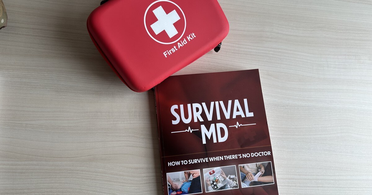 The Survival MD book by Dr. Radu Scurtu on a table next to a red first aid kit