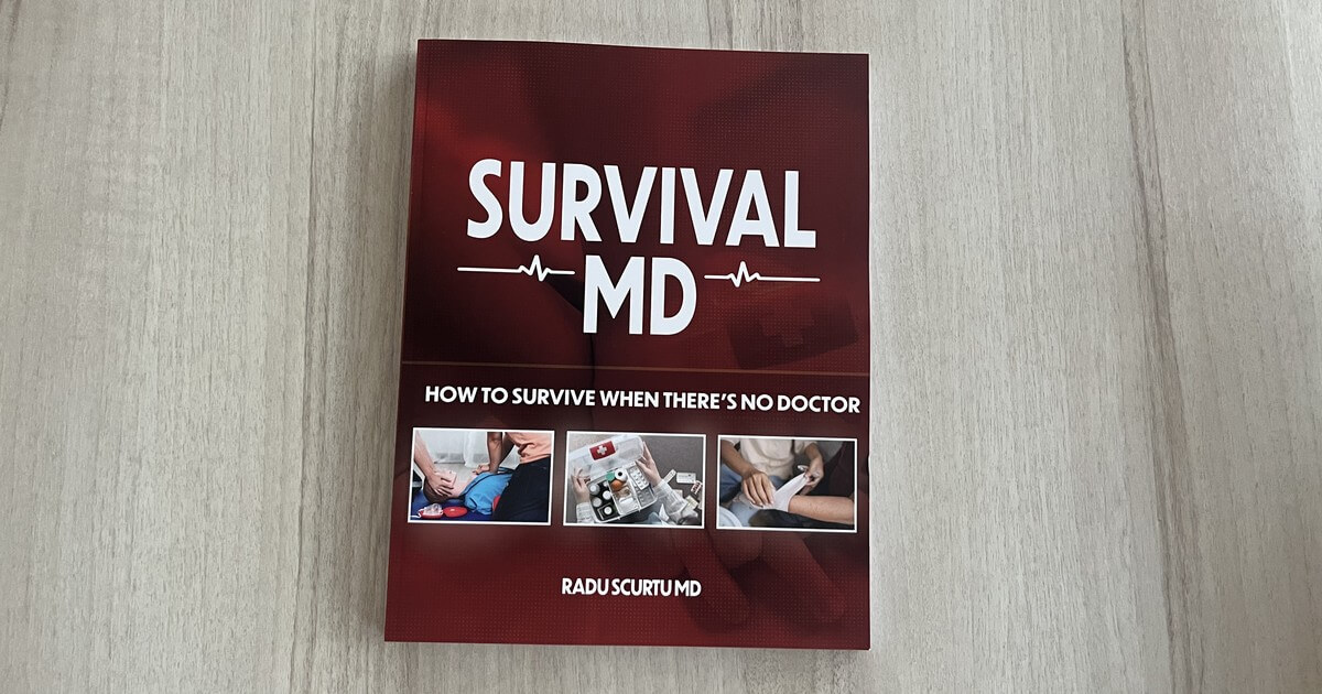 The full-color printed Survival MD book by Dr. Radu Scurtu on a light wooden table